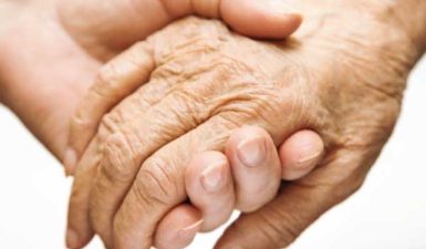 young hand holding an older hand